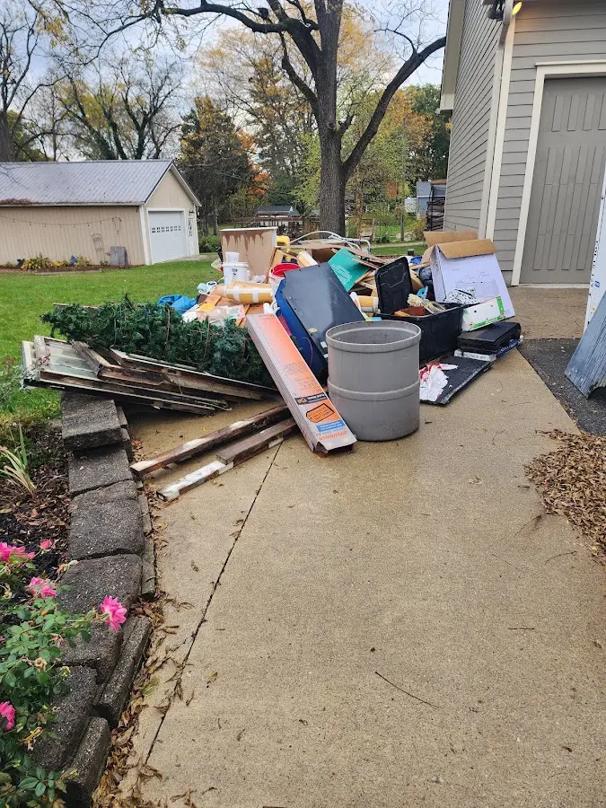 Dumpster being loaded with debris for Estate Cleanout Dumpster Rental in Oak Harbor